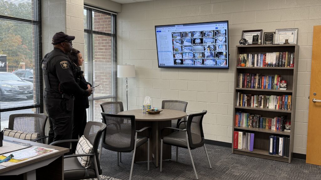 School administration and SRO watching security feeds